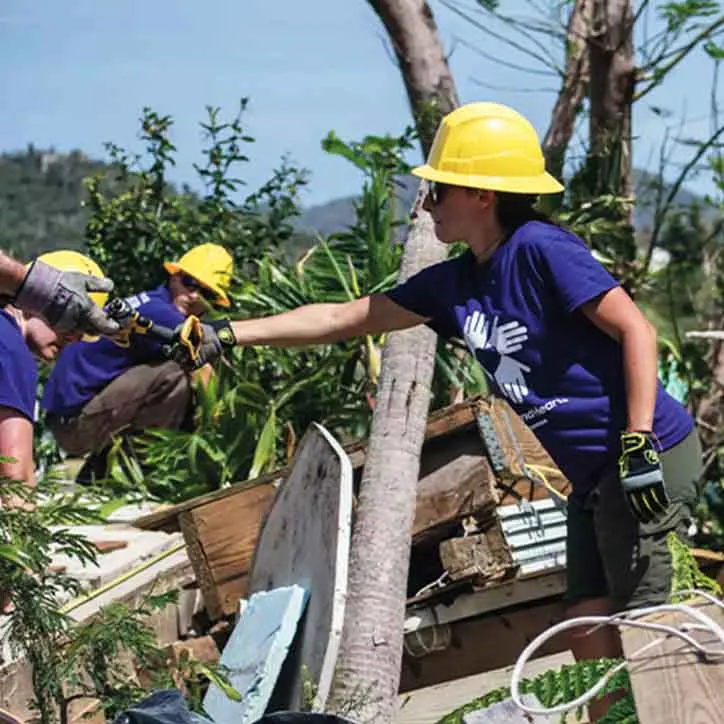 The Island Spirit Fund was formed and we see volunteers helping to clean up after a hurricane in 2018.