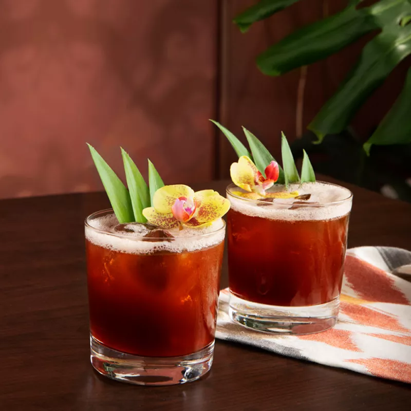 Two Jungle Bird cocktails set on a table ready to enjoy. 