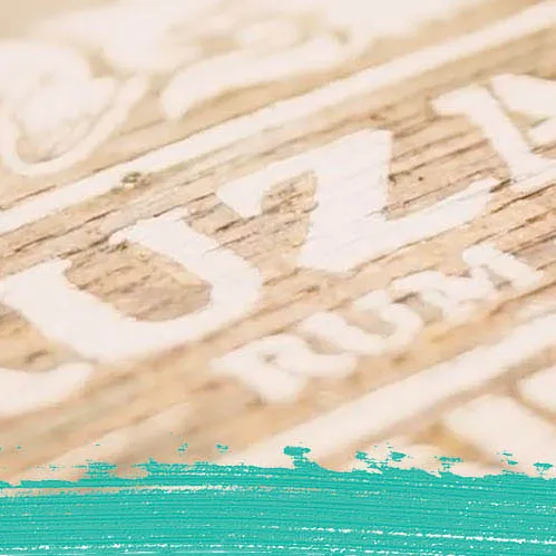 Image of Cruzan Aged Light Rum, Cruzan Single Barrel Rum, and Cruzan Coconut Rum against a background of white oak panels with a turquoise paint smudge and the Cruzan Rum logo.