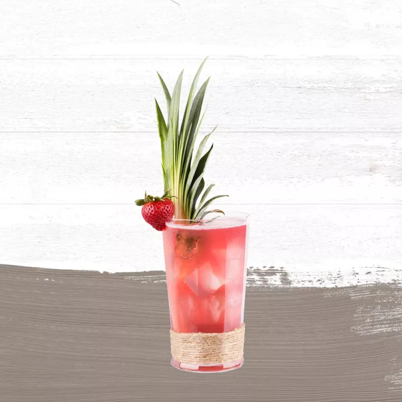 Bay Breeze drink made with Cruzan® Aged Light Rum in a clear glass garnished with a strawberry and pineapple fronds set against a whitewashed wood background with a taupe paint swash.
