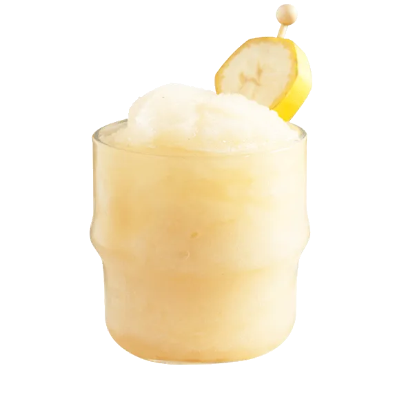 Banana Nana cocktail in a clear rocks glass garnished with a banana slice.
