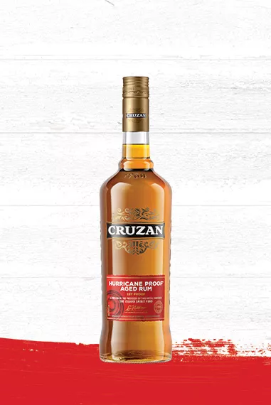 Cruzan Hurricane Proof Aged Rum in a glass bottle set against a whitewashed wood background with a red paint swash.