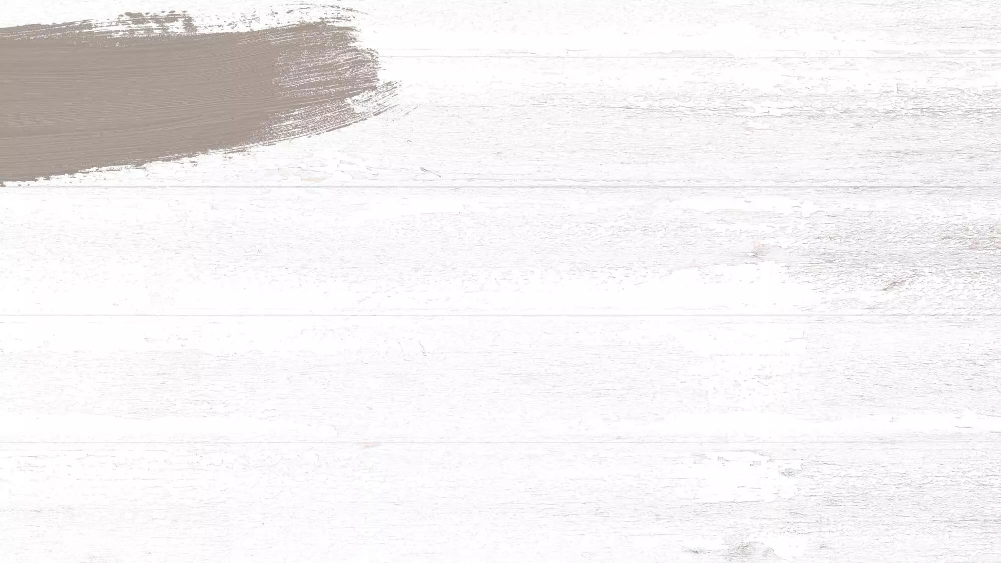Whitewashed wood background with a taupe paint swash in the upper left-hand corner used as a background to showcase Cruzan Aged Light Rum.