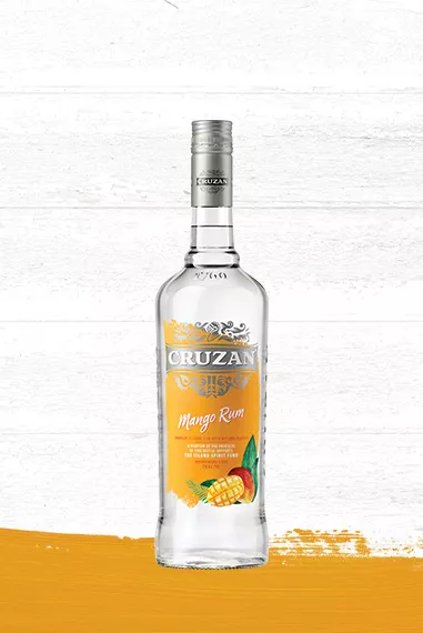 Cruzan Mango Rum glass bottle set against a whitewashed wood background and a mango-hued paint swash.