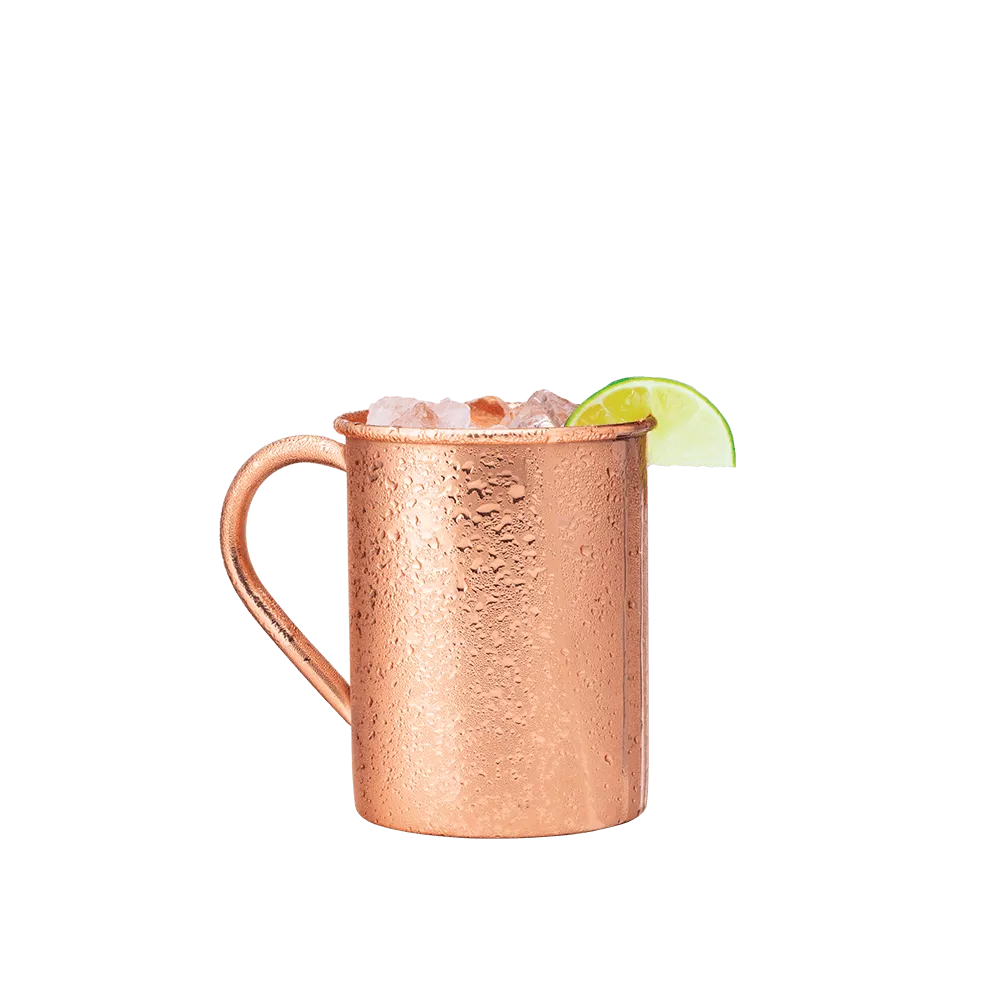 Undertow cocktail in a copper mule mug, garnished with a slice of lime.