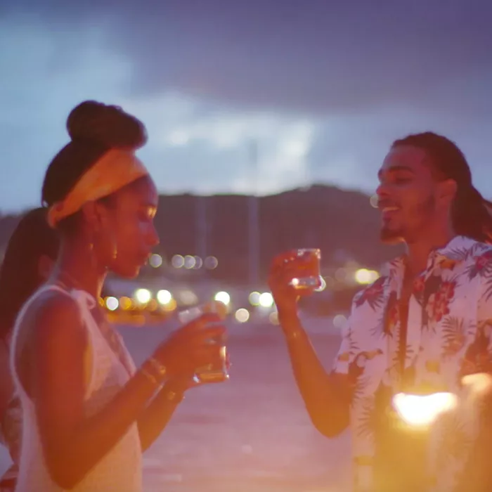 A couple drinking mixed rum drinks created at a rum distillery in St. Croix.