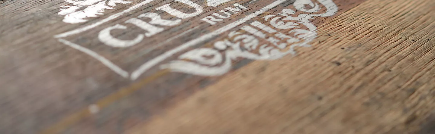 Cruzan Rum label stamped on an oak barrel.