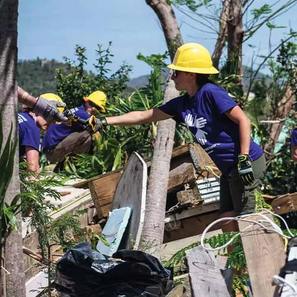 Volunteers help with the clean up after a hurricane hit St. Croix.