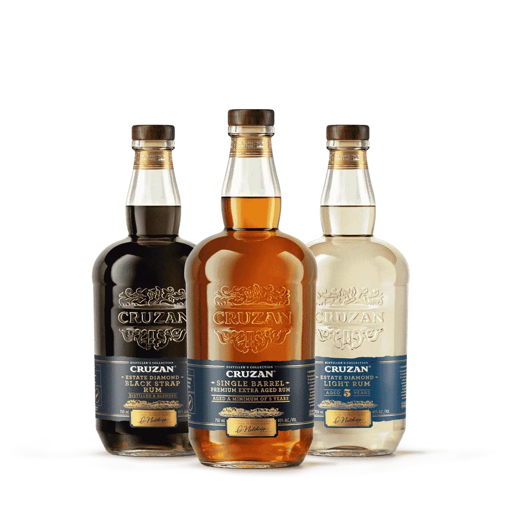 Image of Cruzan Single Barrel Rum, Cruzan Black Strap Rum and Cruzan Estate Diamond Light Rum bottles in front of a wood background with a dark blue paint swash.