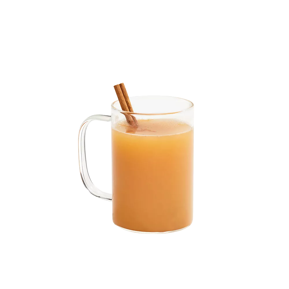Hot apple cider mixed with Cruzan® Island Spiced Rum in a clear mug garnished with a cinnamon stick.